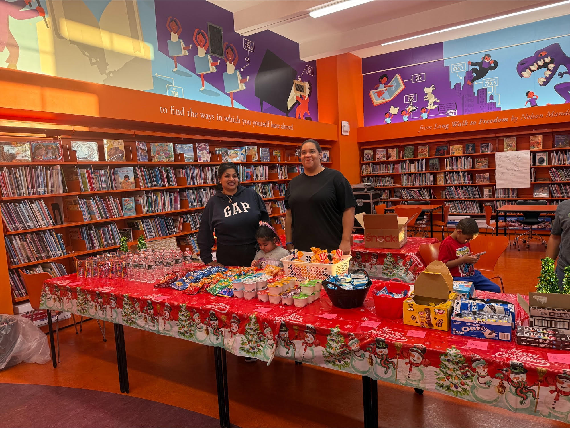 Two people at a snack table in a library