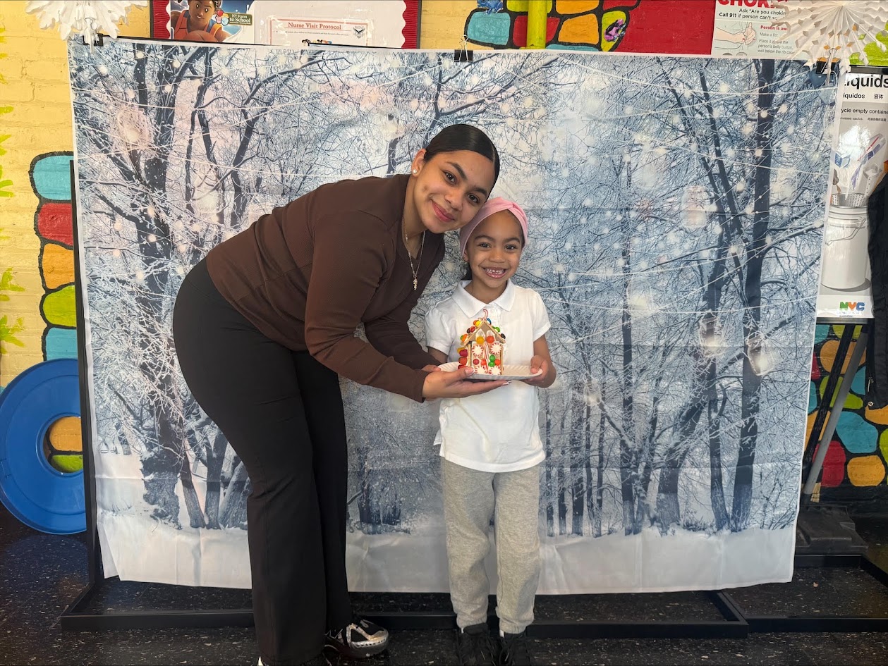 Adult and child holding a craft