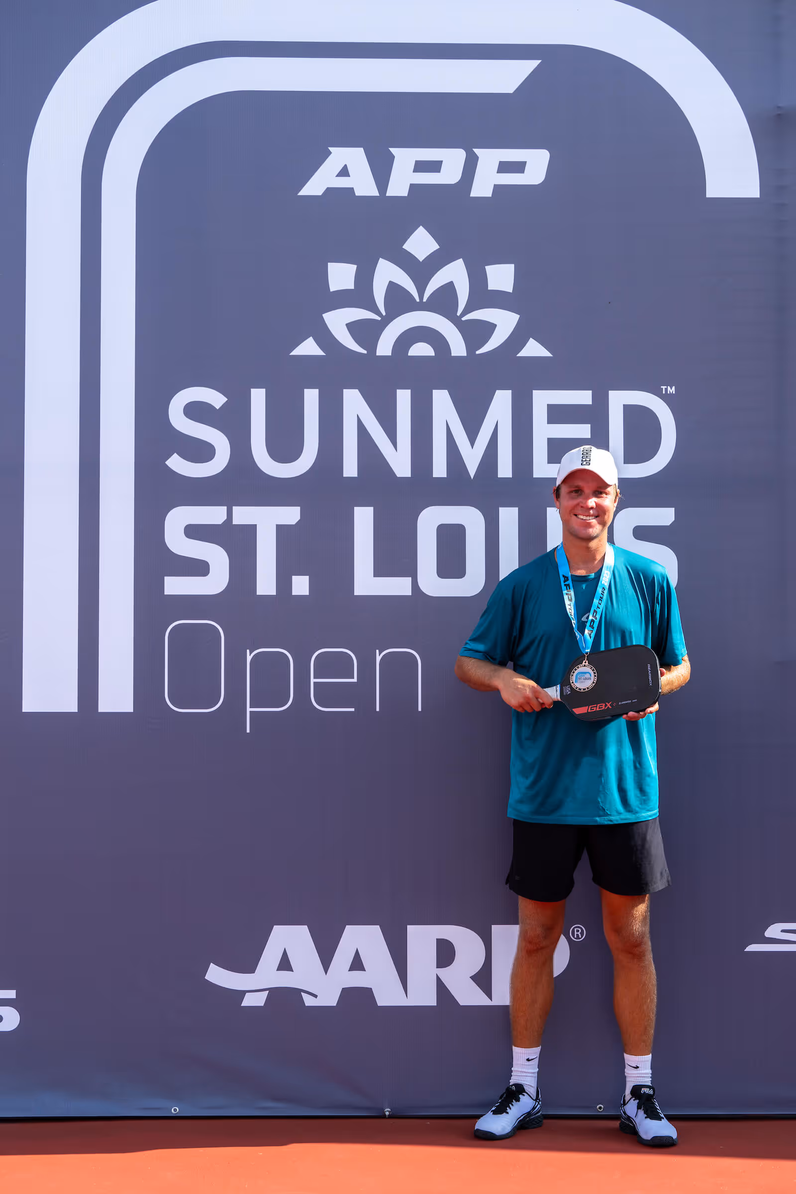 Chris Haworth celebrates a bronze medal in men's pro singles at the APP Sunmed St. Louis Open