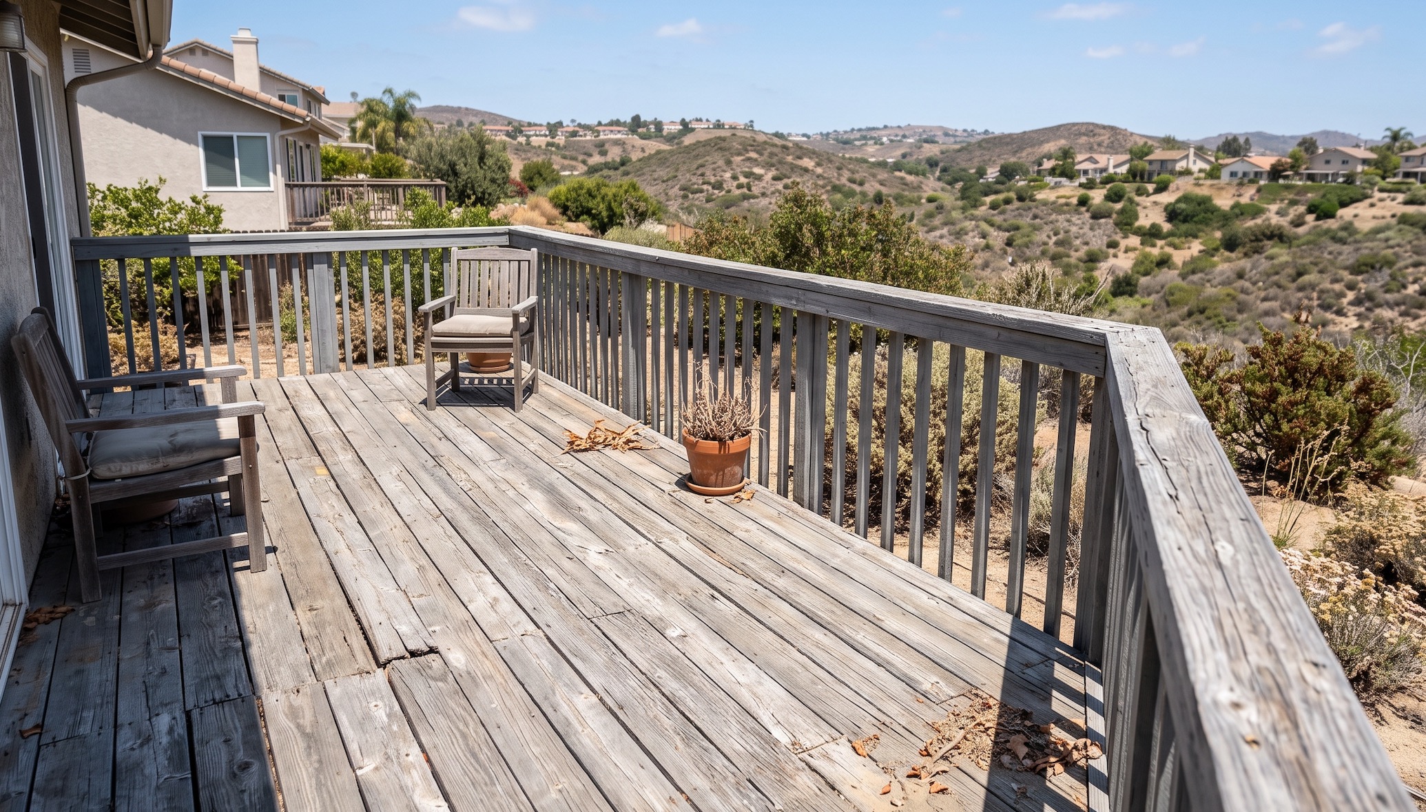 Weathered gray wood deck and railing overlooking the San Diego hills