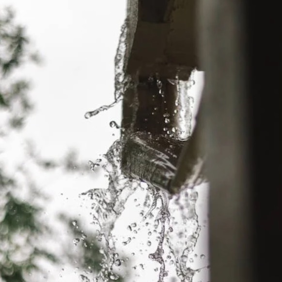 Water overflowing from a clogged rain gutter
