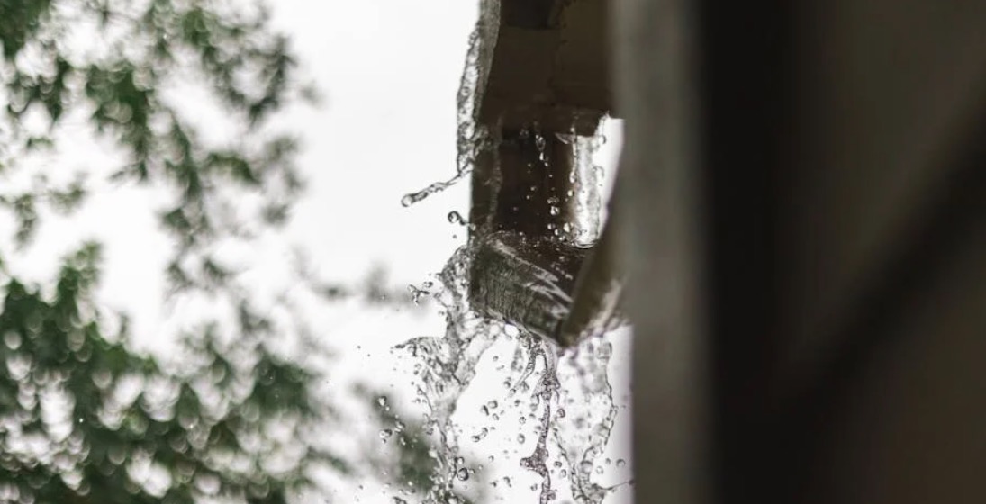 Water overflowing from a clogged rain gutter