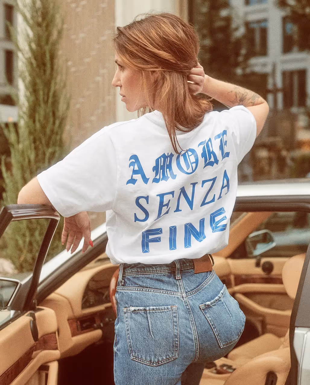 Person trägt ein T-Shirt mit Schriftzug auf dem Rücken