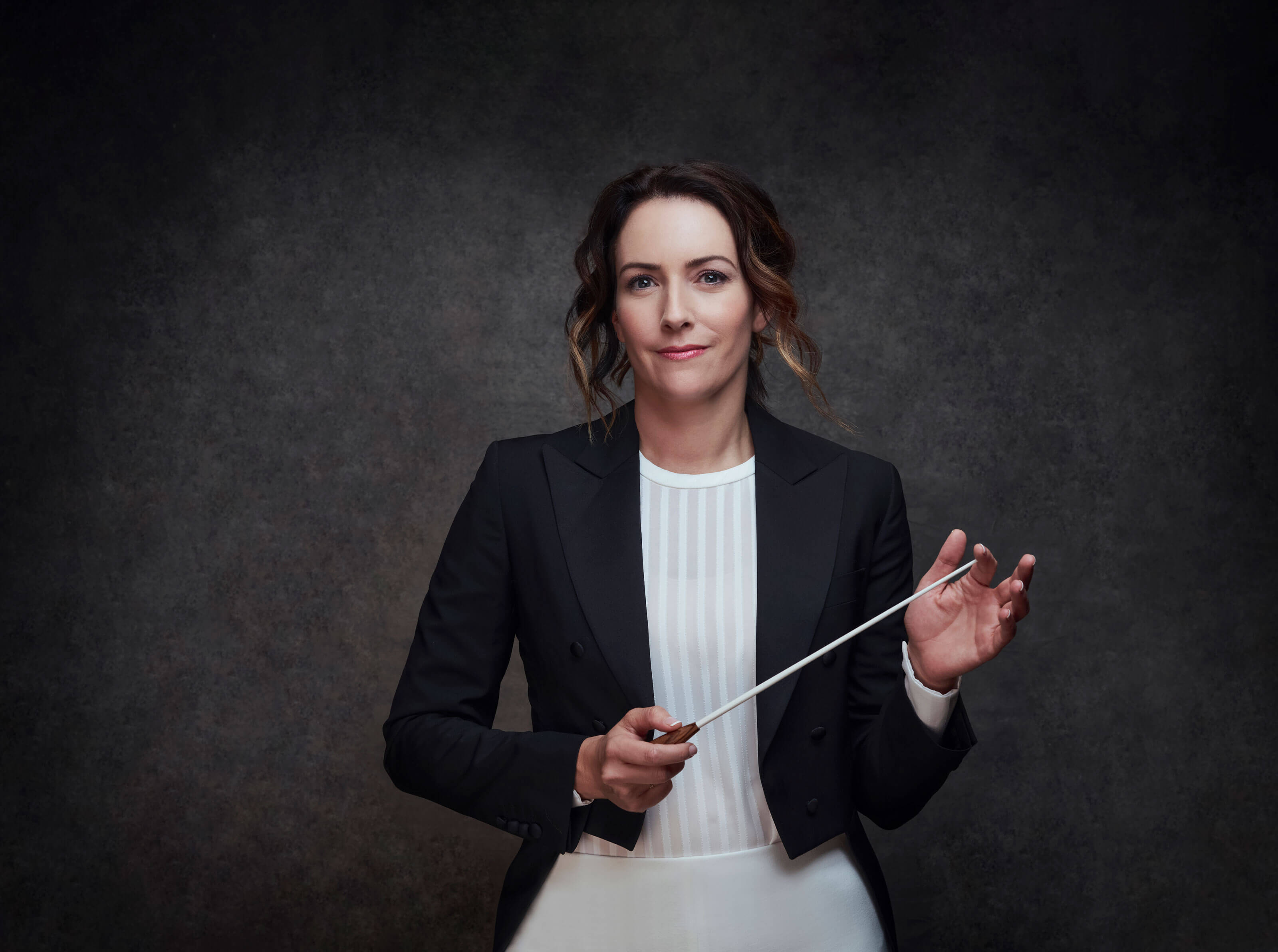 Portrait of Conductor, Alondra de la Parra, leading the orchestra at Daphne Awards