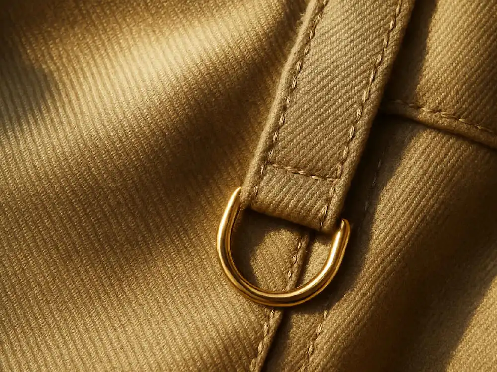 A close-up of luxurious gold fabric, illustrating the detailed textures achievable with an AI fashion design guide.