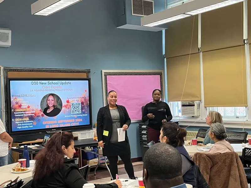 An ACE presenter speaks with families beside a presentation screen