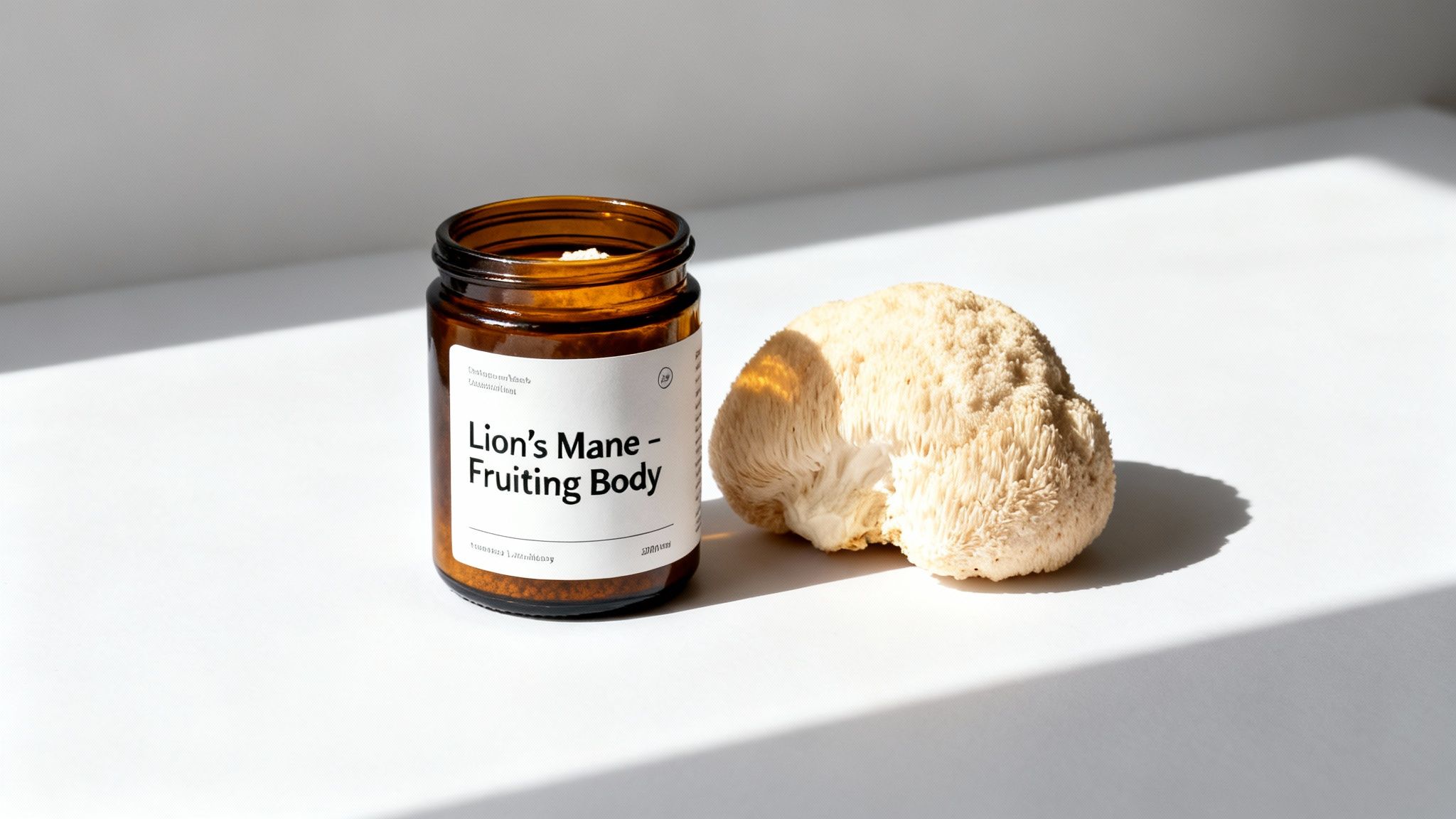 An amber jar labeled Lion's Mane supplement next to a fresh Lion's Mane mushroom.