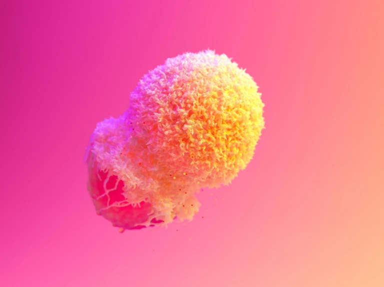Close-up of a vibrant yellow and pink cancer or immune cell against a pink gradient background.