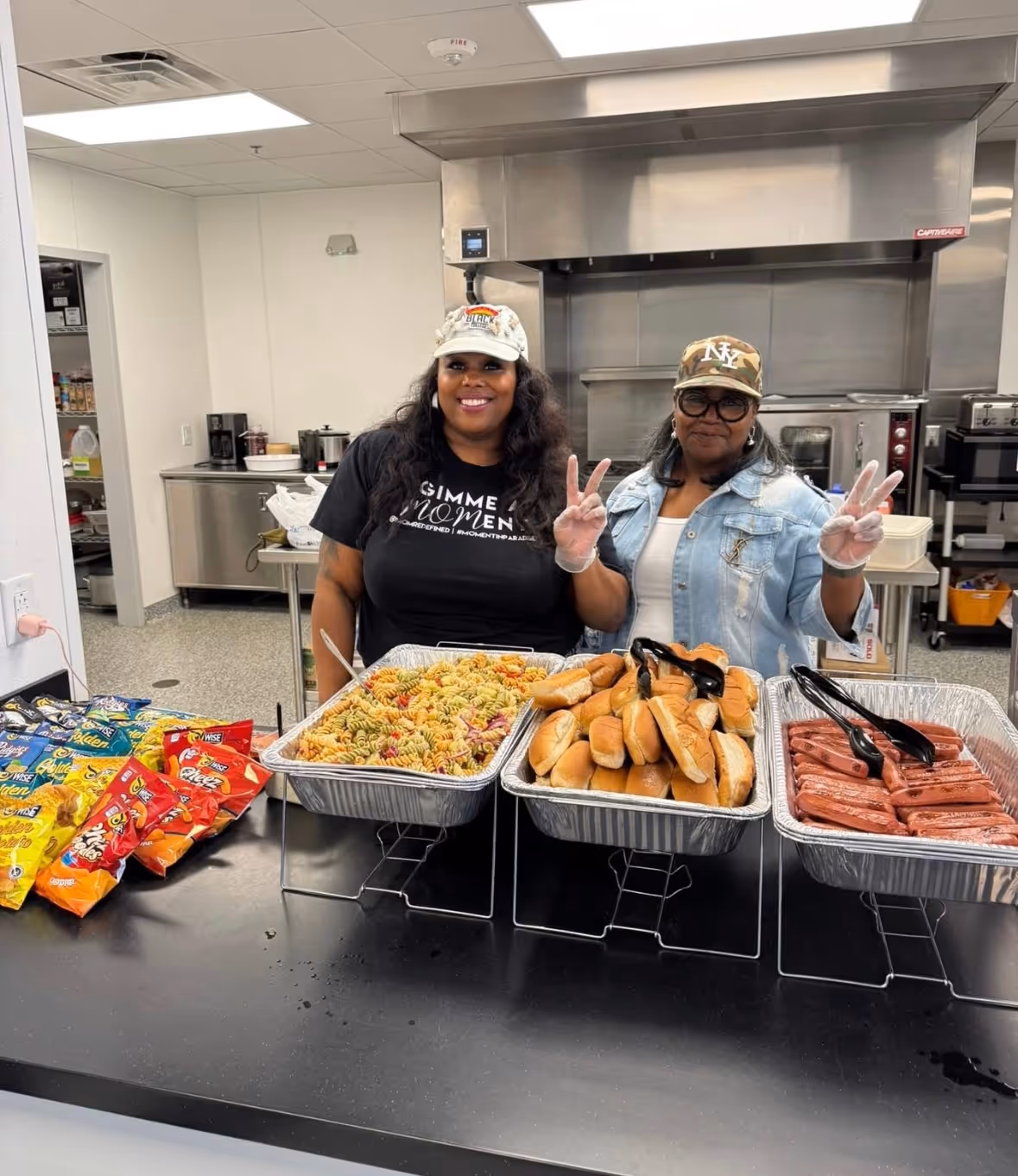 Two volunteers helping with dinner at the women's shelter