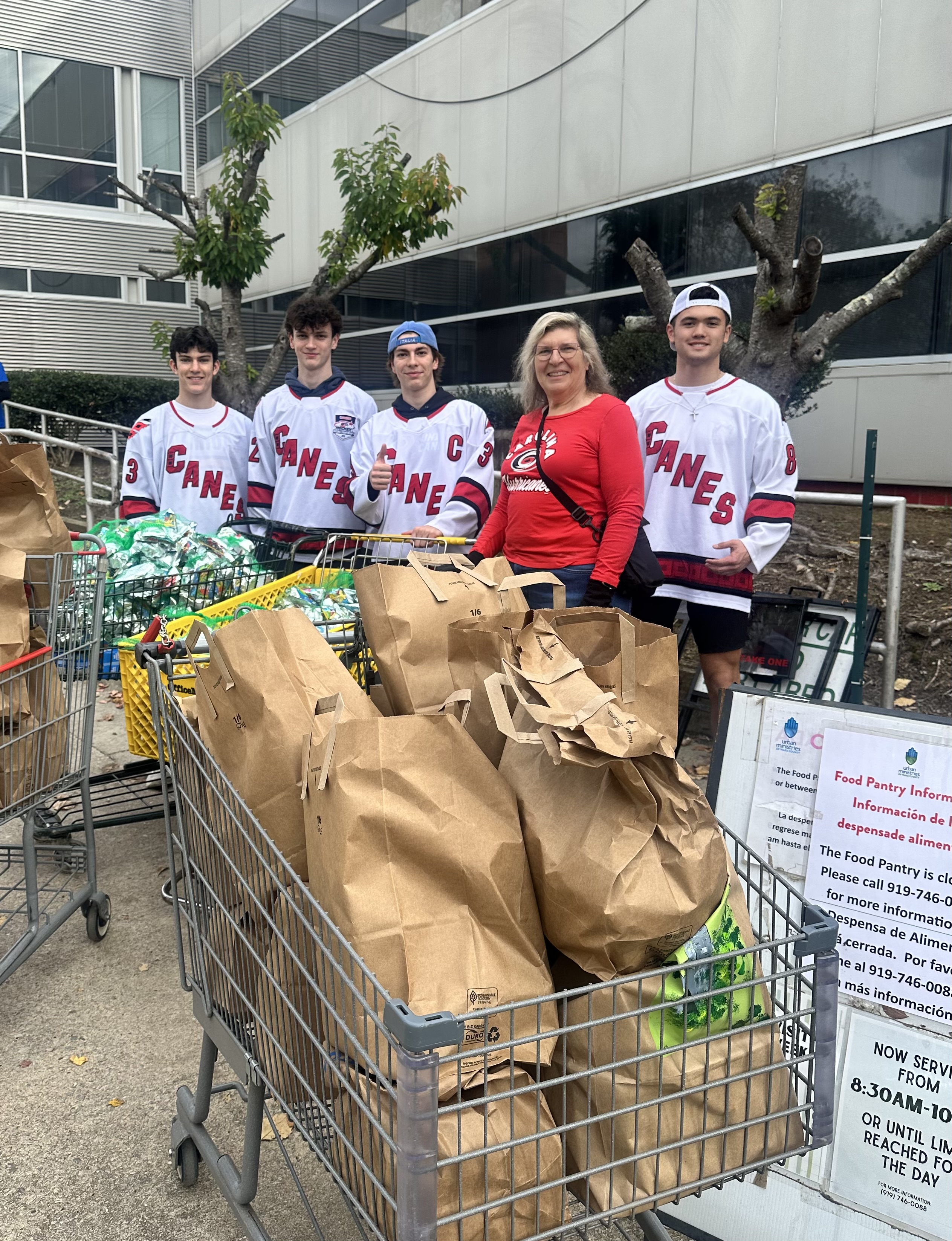 Urban ministries staff, Carolina Hurricanes Foundation and members of the Carolina Hurricanes Fan Club helping at the food pantry