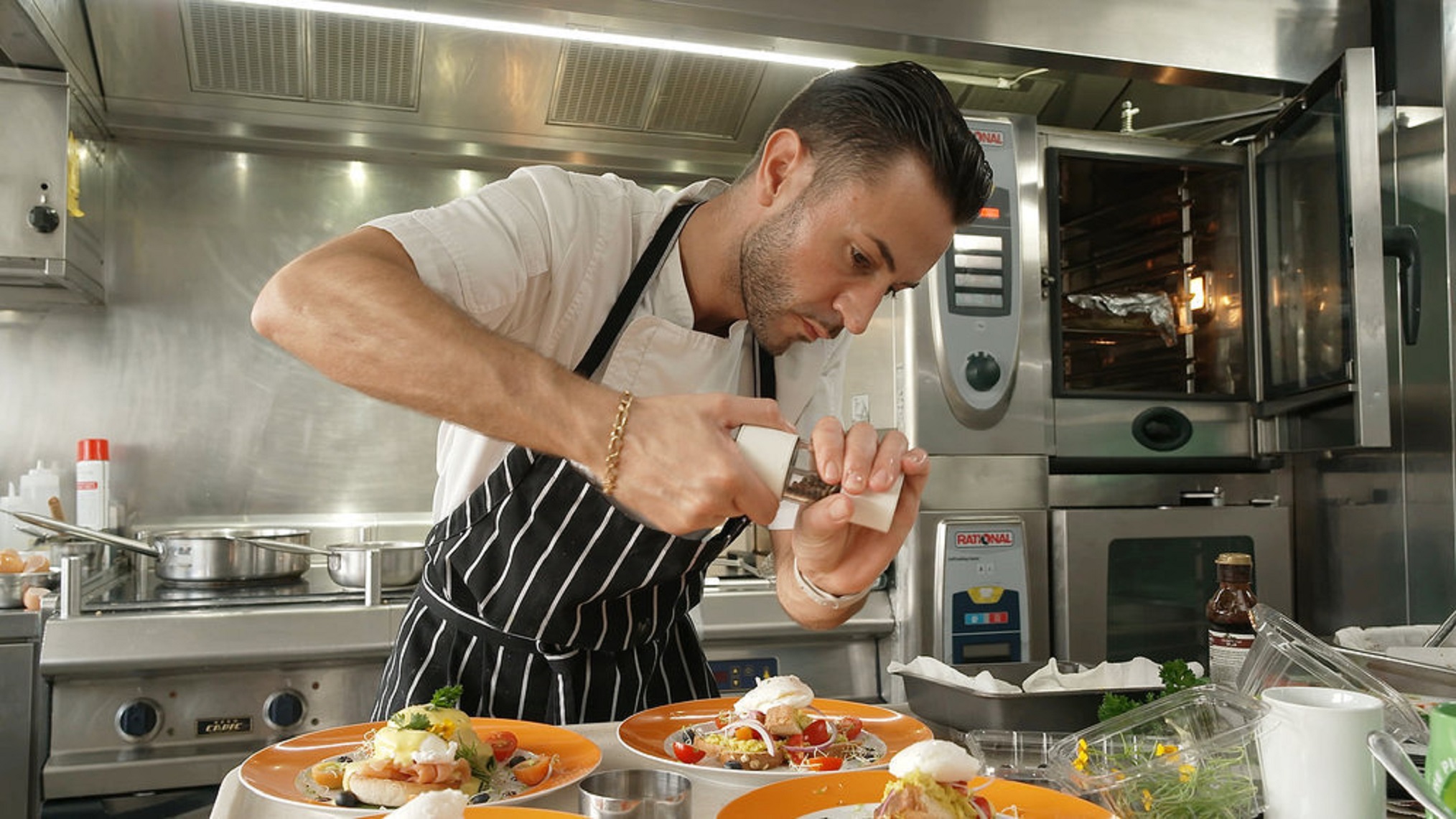 chef anthony iracane putting pepper on dish