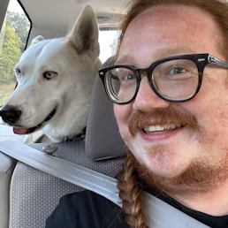 A selfie of Ethan and their dog Nova looking happy in a car.