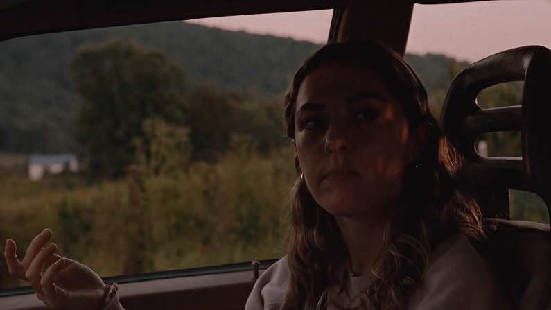 Blonde woman sitting in the passenger seat of a car