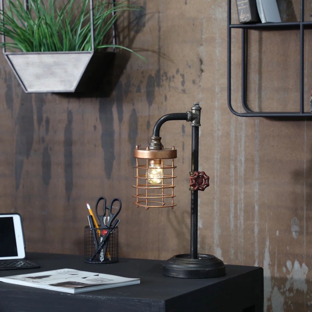 Industrial steampunk pipe table lamp with copper cage shade and valve handle detail