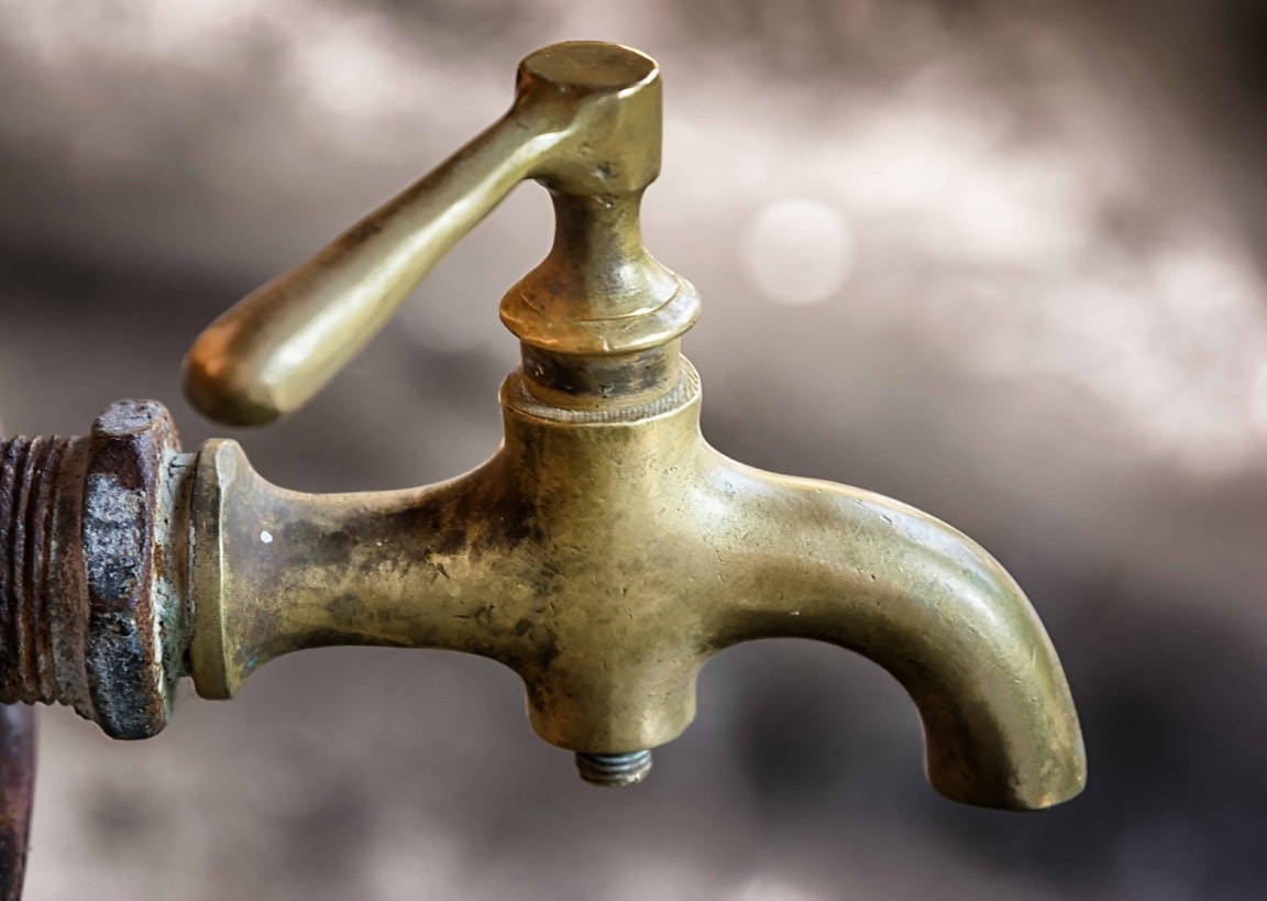 A brass spigot with visible patina.