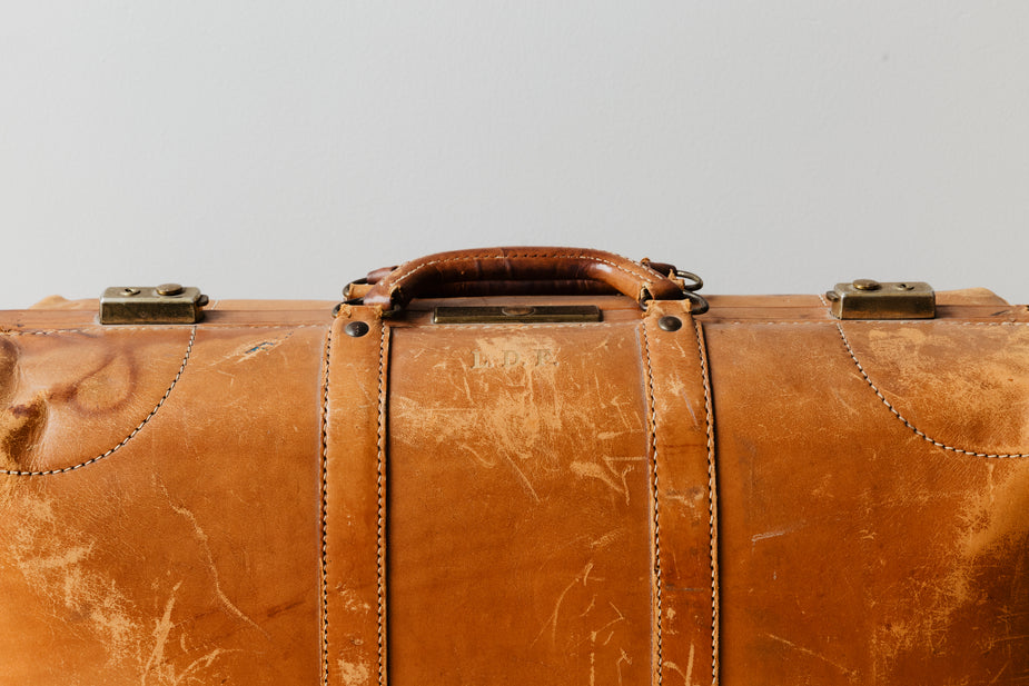 A well-worn leather suitcase