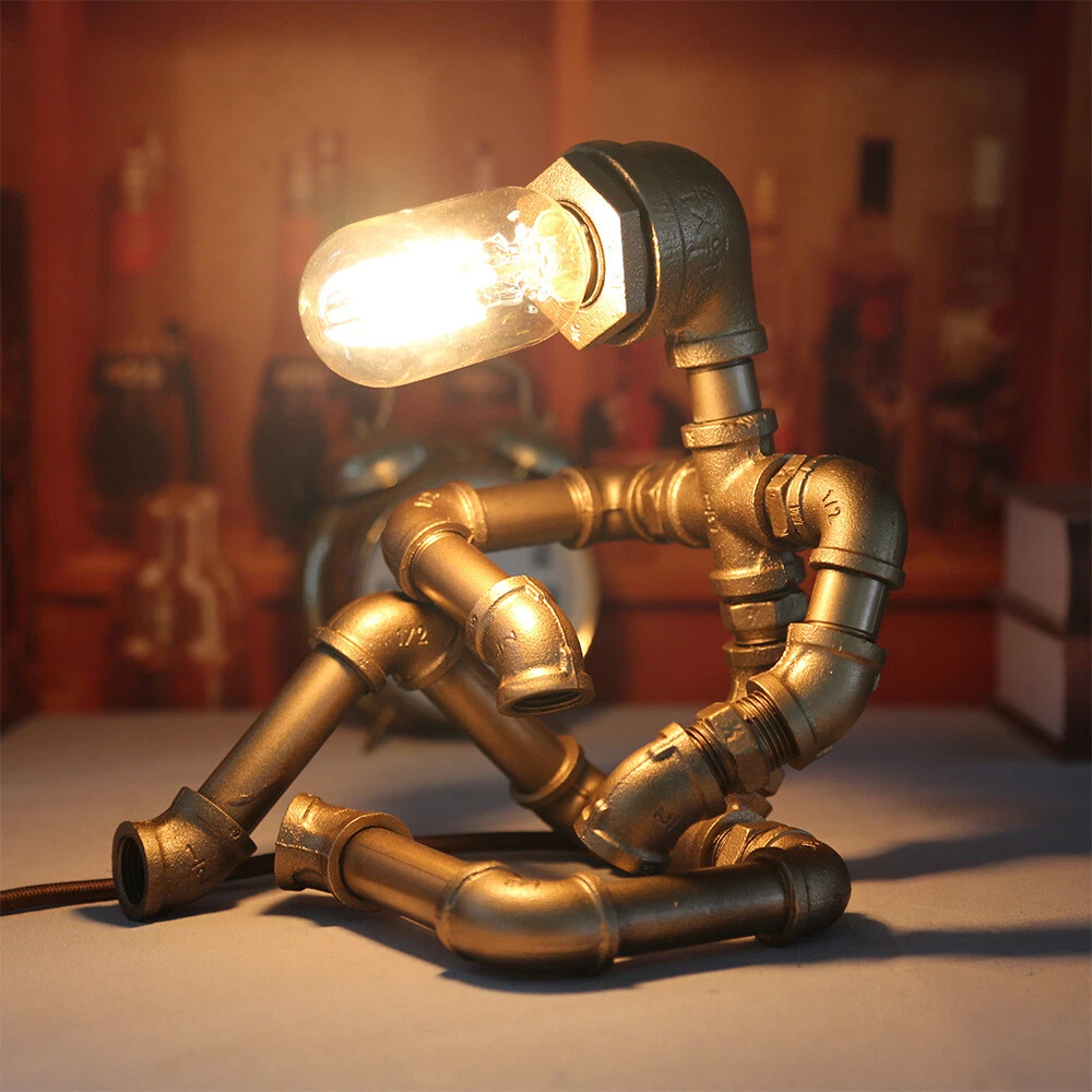 Industrial pipe lamp shaped like a seated figure