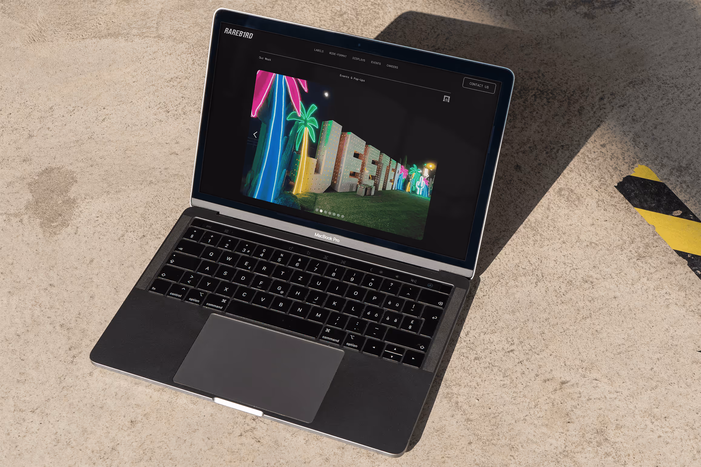 Rareb1rd website event page with Jeeter event build on laptop with concrete floor