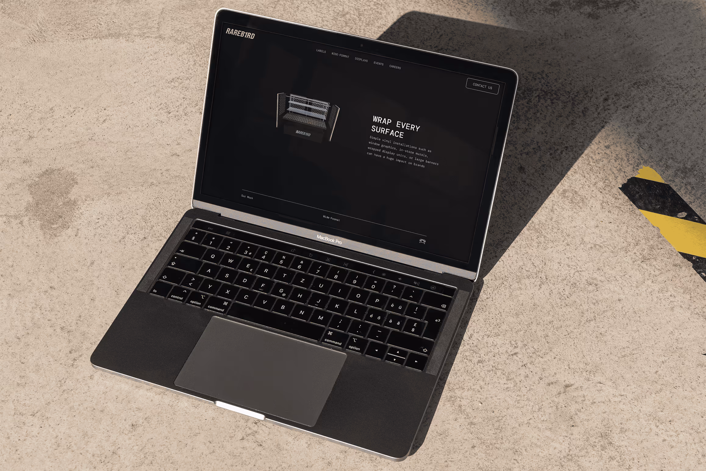 Rareb1rd website wide-format page with 3D render on laptop with concrete floor