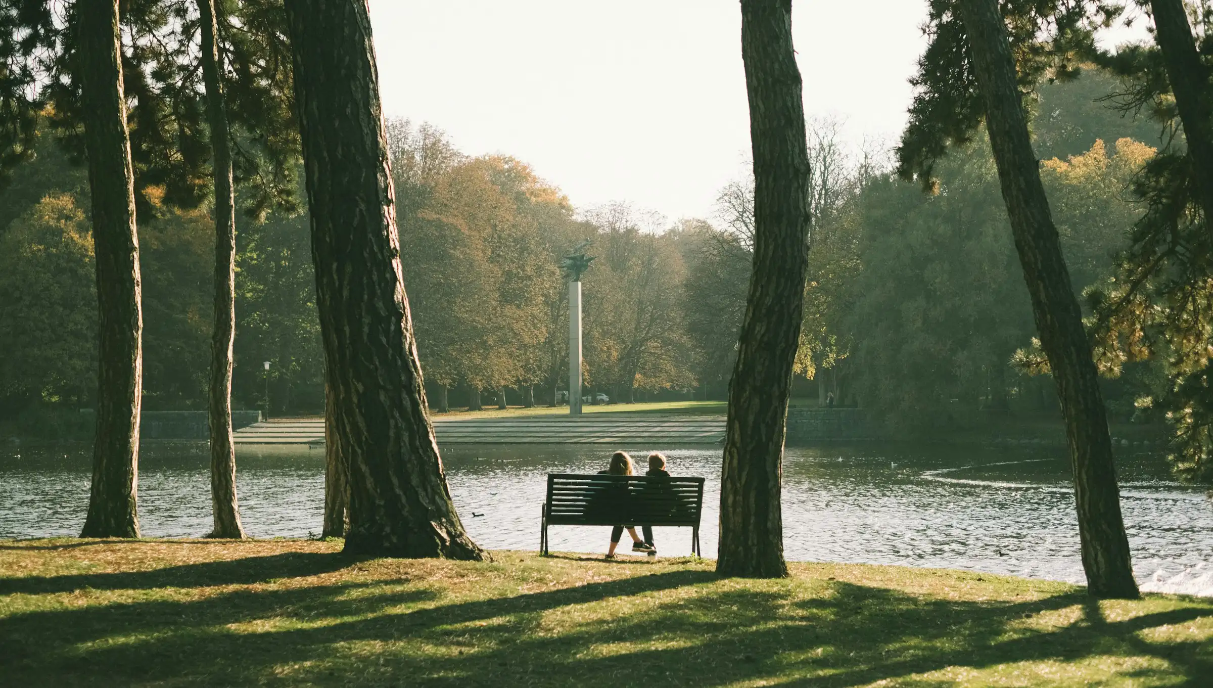 A couple sitting on a park bench