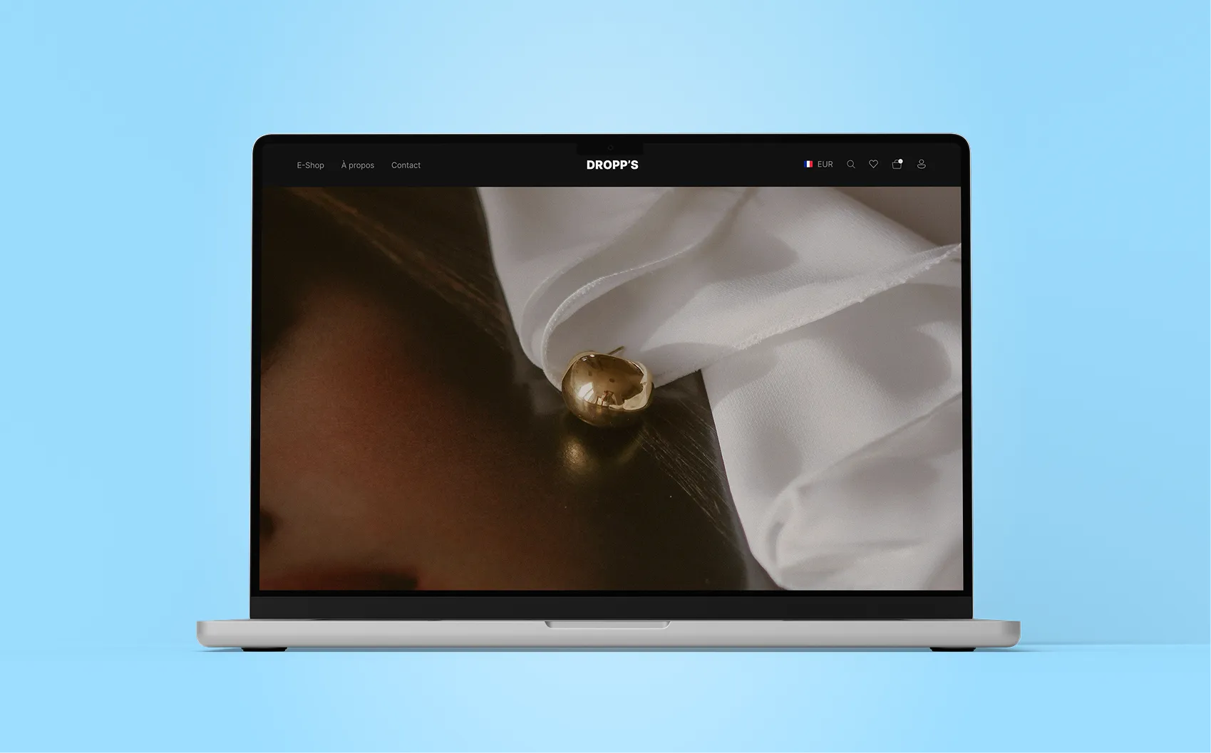 A laptop with the close-up of a woman with the golden earings.
