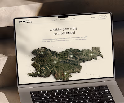mijnslovenie.com - Laptop screen showing a website with a 3D map of Slovenia labeled as a hidden gem in the heart of Europe.