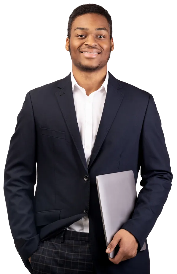 Young man dressed in a smart suit, smiling and holding laptop