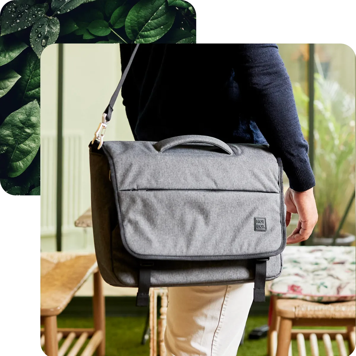 Person in a navy sweater and white pants carrying a grey Hotbox branded Flow messenger bag indoors.