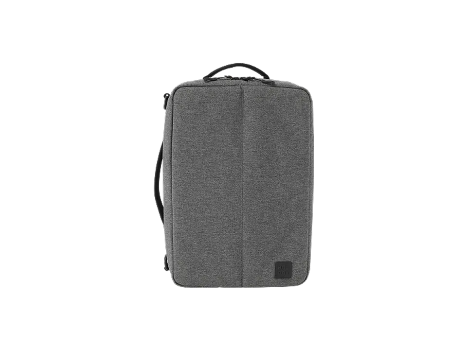 Grey rectangular adapt backpack with a top handle and side strap on black background.