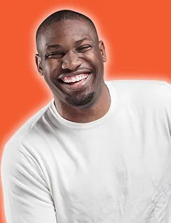 Smiling man wearing a white shirt against an orange background.