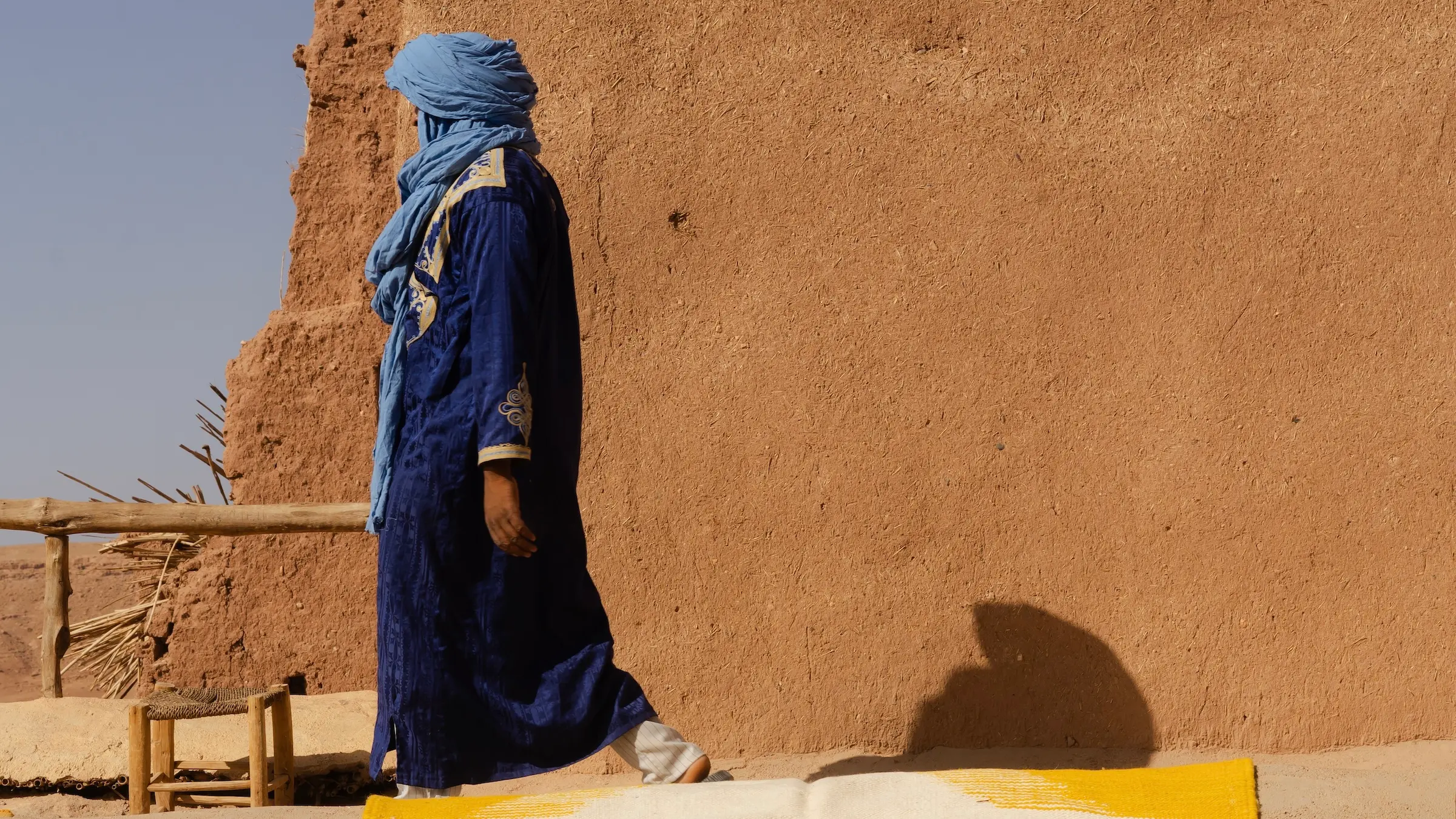 Amazigh berber man walking along a narrow passage in the Atlas region of Ait Ben Haddou in Morocco