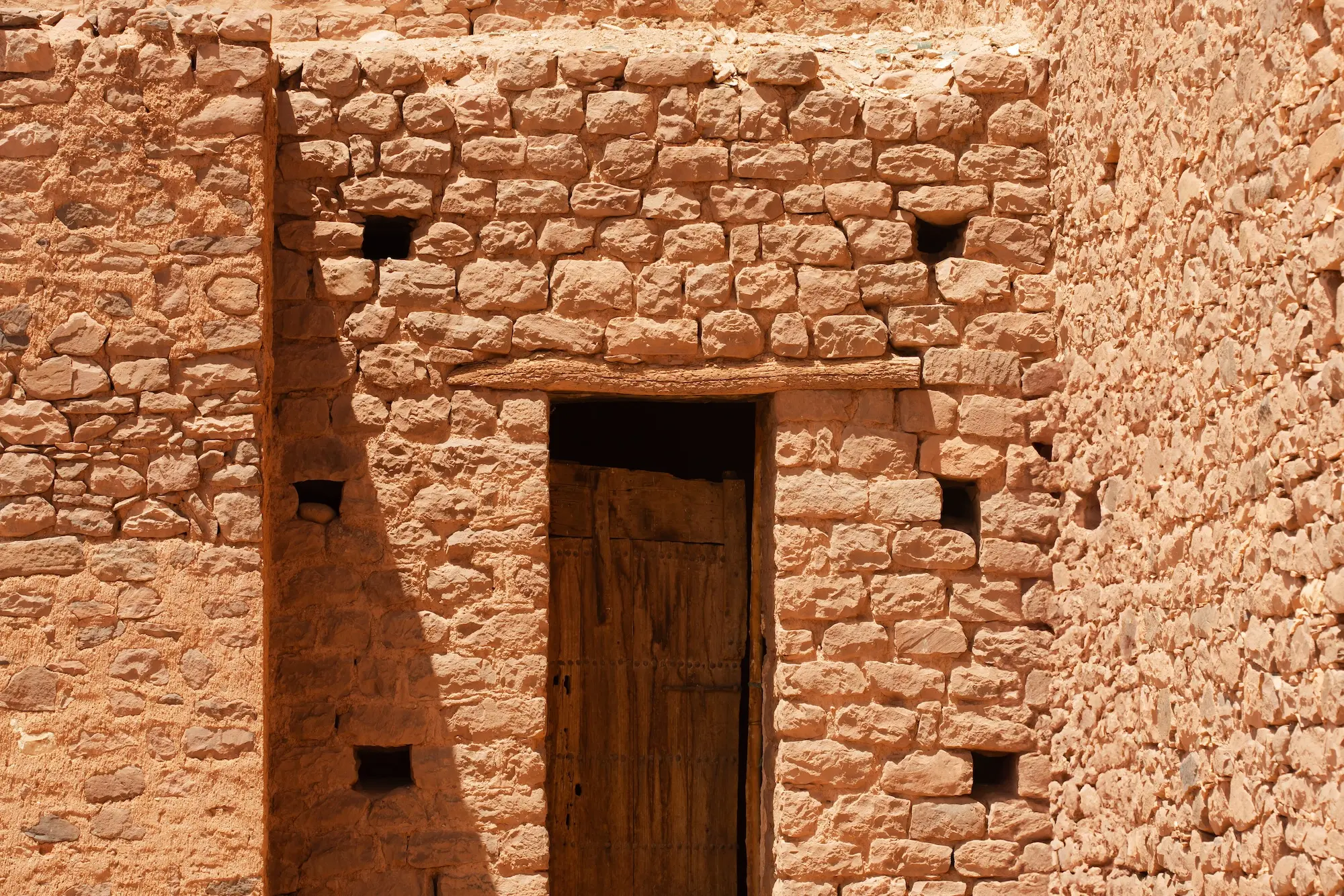 Traditional mudbrick wall framing a door in Morocco