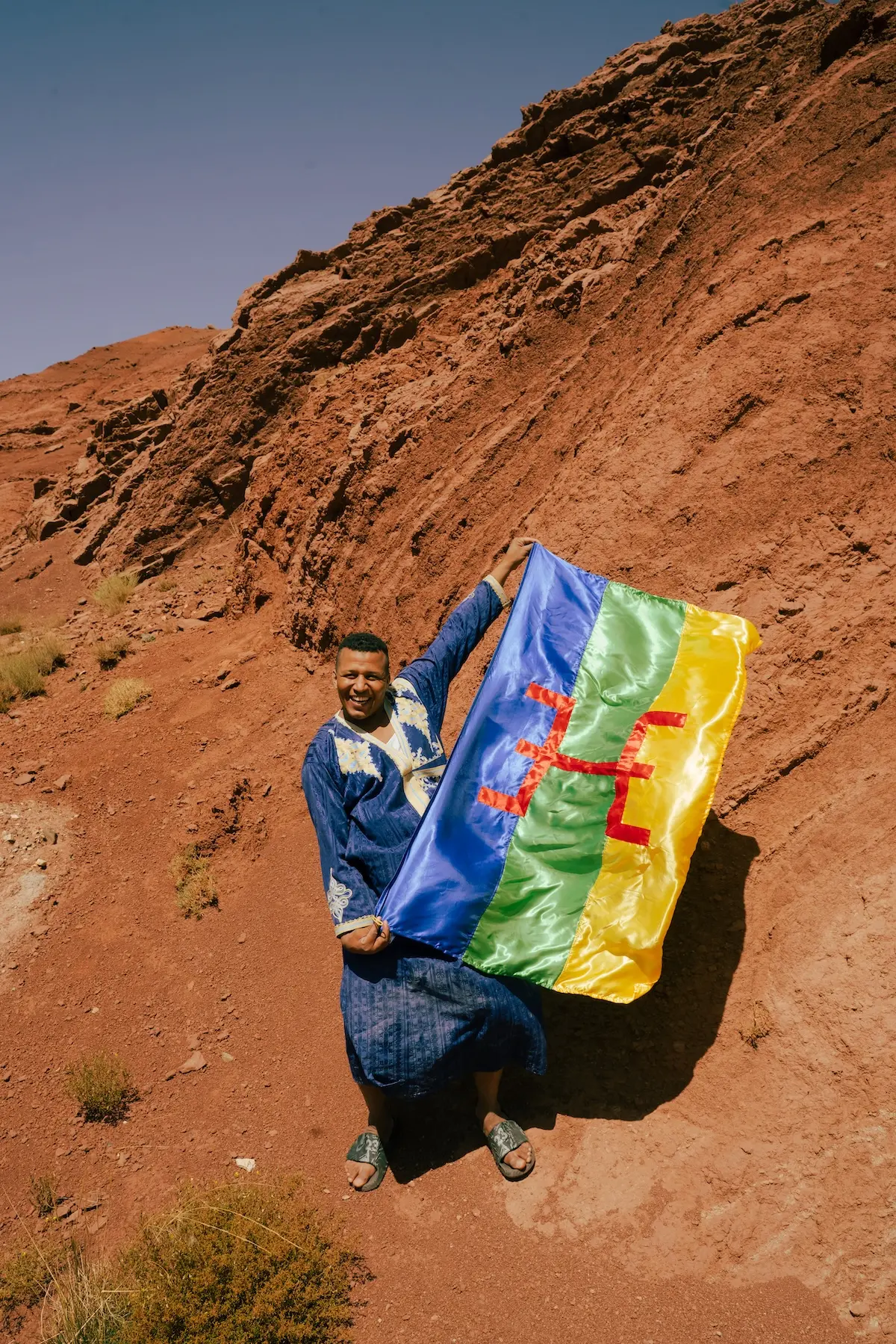 The traditional Amazigh symbol of free man being held in a flag 