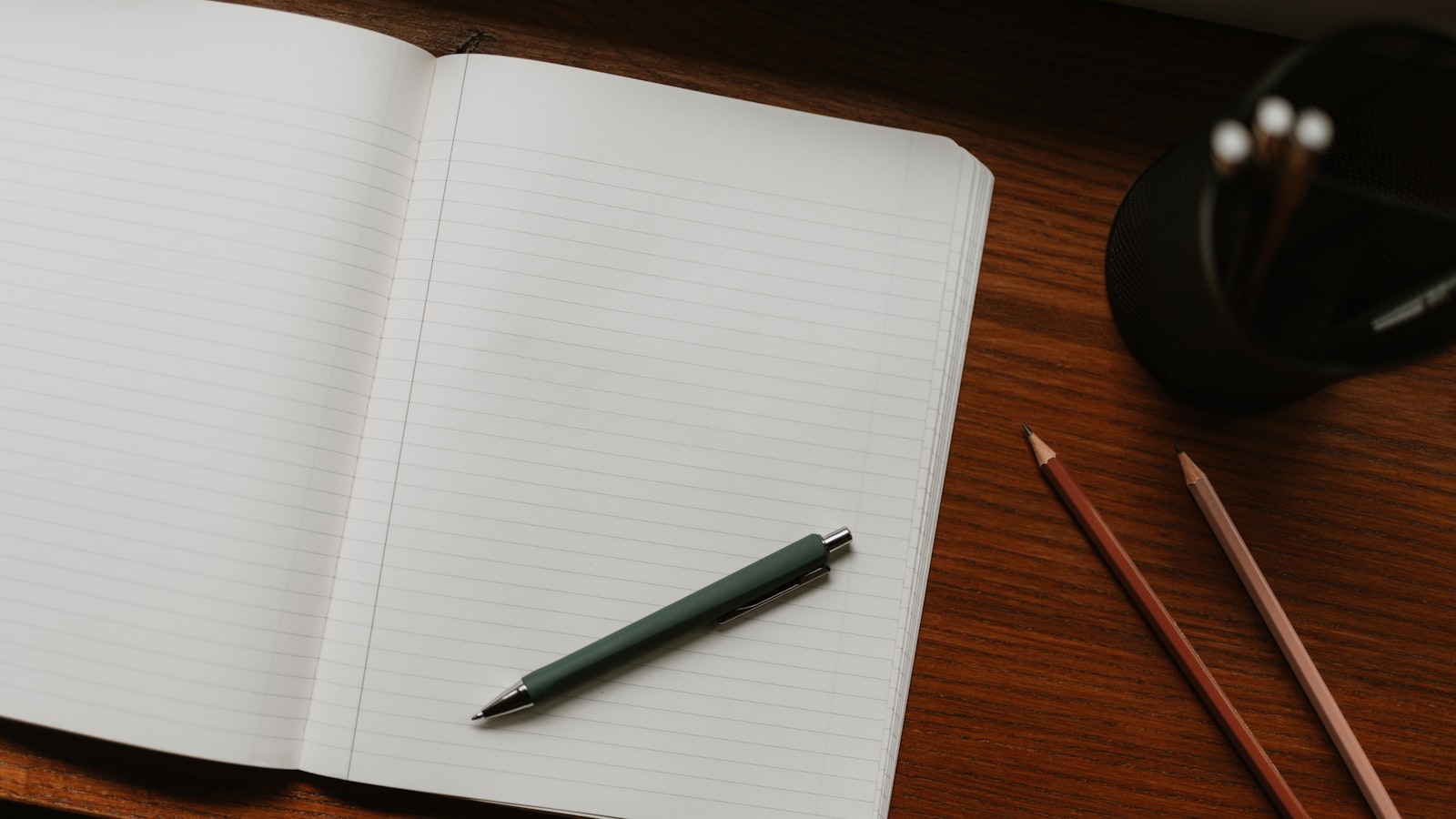 Carnet ouvert avec stylo et crayons pour planifier un calendrier