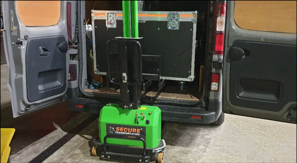 Secure Transportation loading a van with client's equipment using electric forklift and secure boxes.