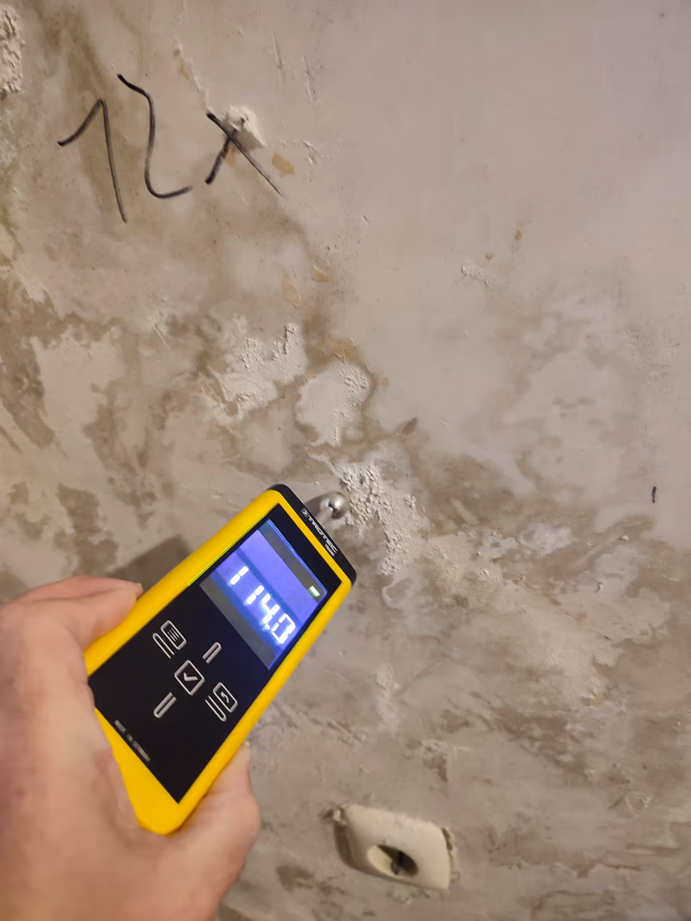 Techniker misst Schimmelbelastung in einem Raum mit professionellem Messgerät, Schimmel-Konzepte Expertise sichtbar