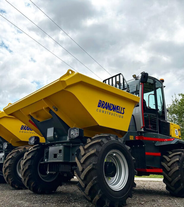 Smiling business owner or finance executive in a modern warehouse environment, representing the financial control and efficiency gained through ONSO's automated accounting software.