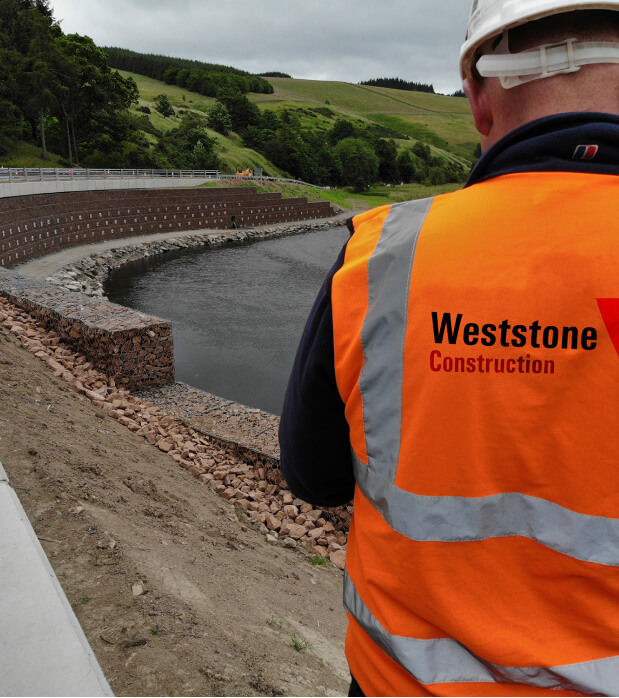 Experienced construction manager or project director holding a tablet on site, illustrating how ONSO provides real-time digital procurement and cost management for field operations.