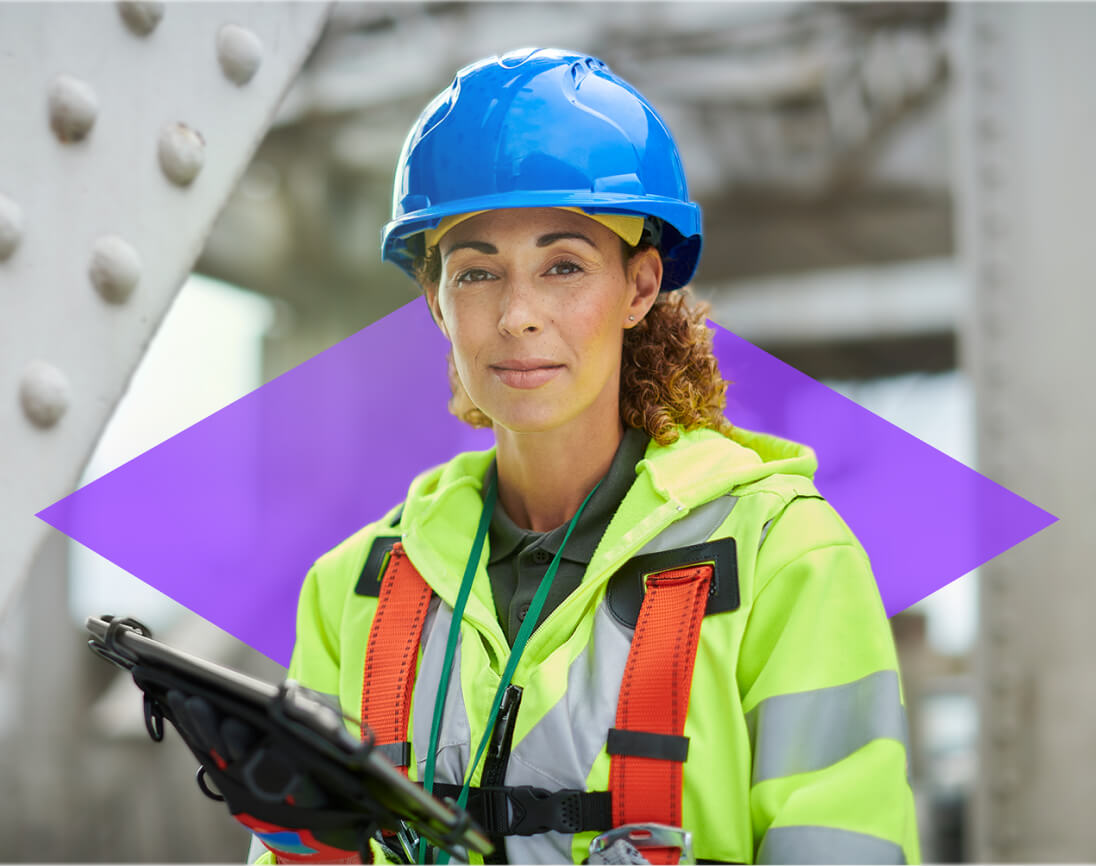 Female project manager or onsite operative in safety gear using a tablet, demonstrating ONSO's user-friendly and accessible procurement software tailored for all users in the supply chain.