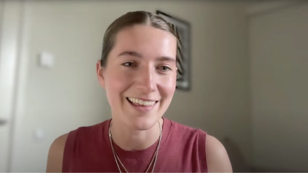 Provet team member smiling warmly in red sleeveless top