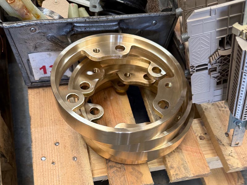 Freshly machined bronze slip ring component with a bright, true finish