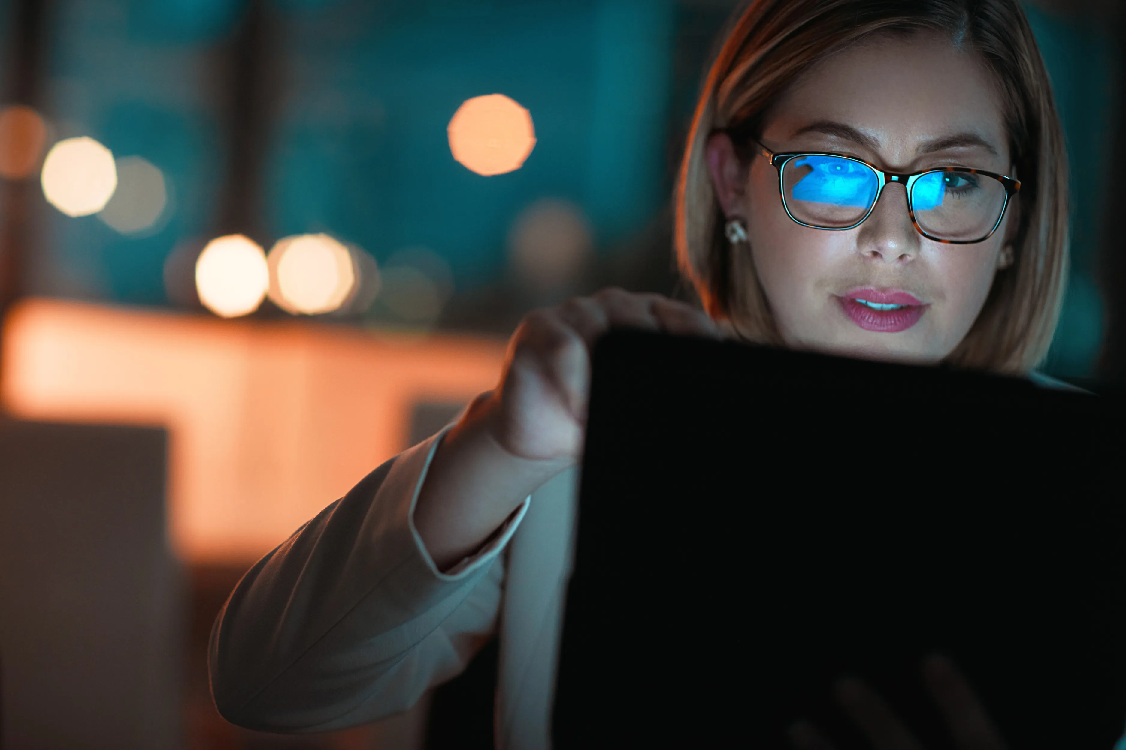 Business team in a meeting reviewing documents around a table in a modern office.