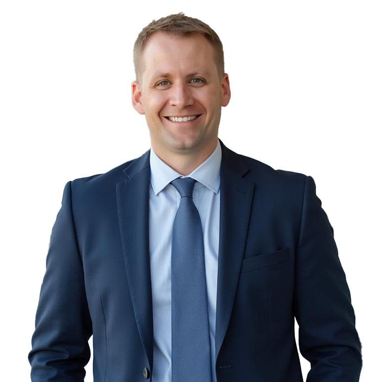Portrait of Aaron Kennelly with a friendly and inviting smile, dressed in a blue suit.