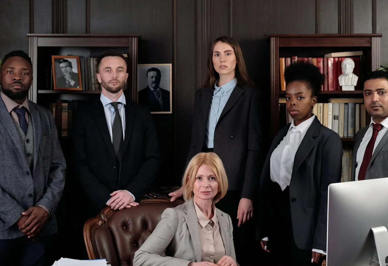 Group of lawyers standing together in an office.
