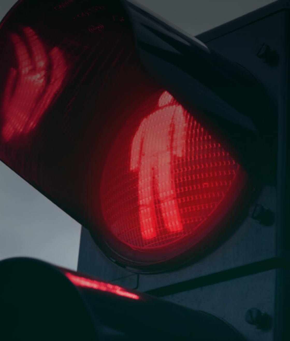 Red pedestrian stop signal at a traffic light.