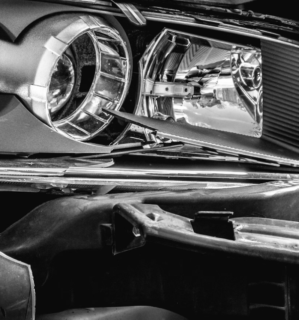 Close-up of a damaged car headlight assembly.