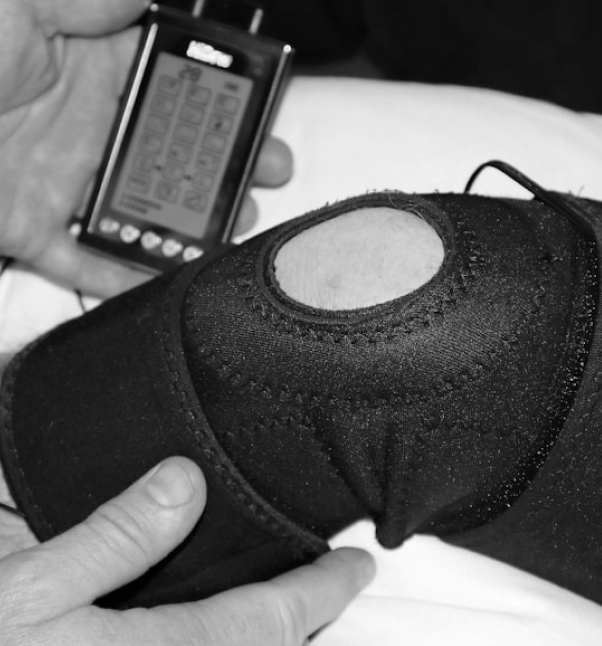 Knee brace being adjusted with a handheld device