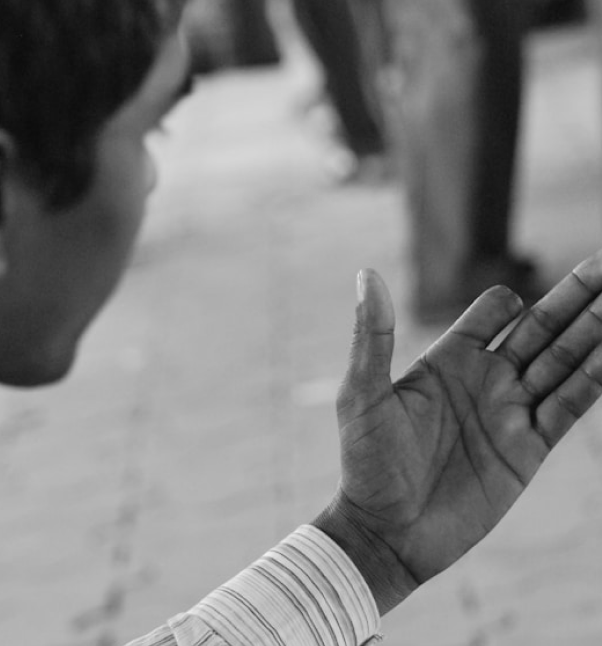 Person gesturing with their hand during a conversation.