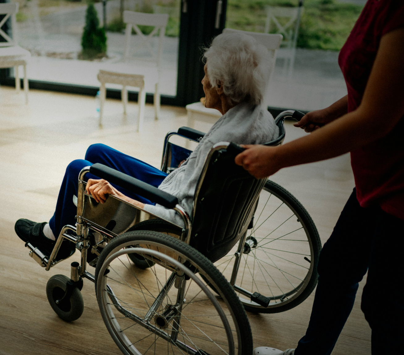 Woman holding her neck while looking at her phone near a car accident.
