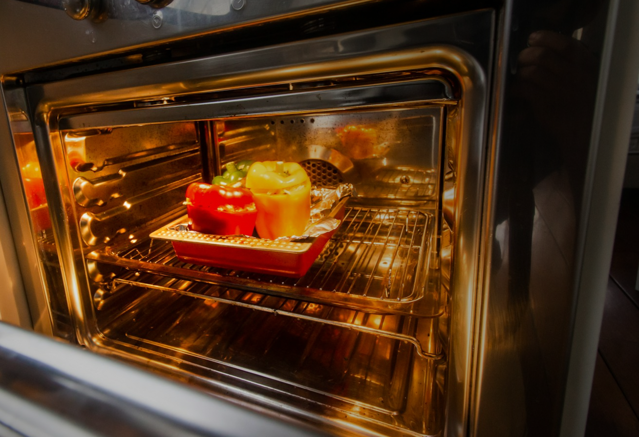 Woman holding her neck while looking at her phone near a car accident.